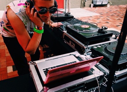 A DJ spinning on the outdoor patio